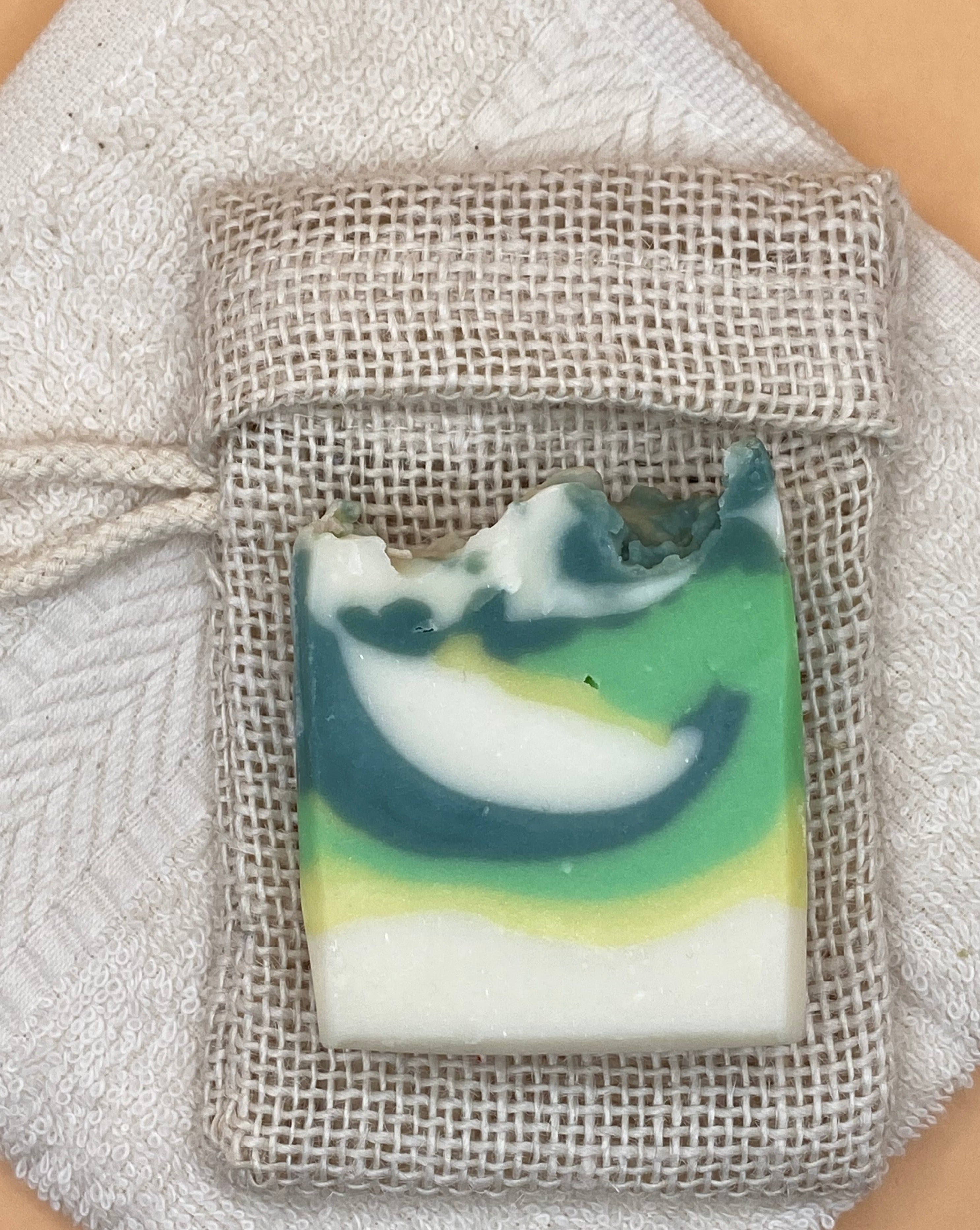 Ginkgo-Limette Soap laying on a soap saver bag.
