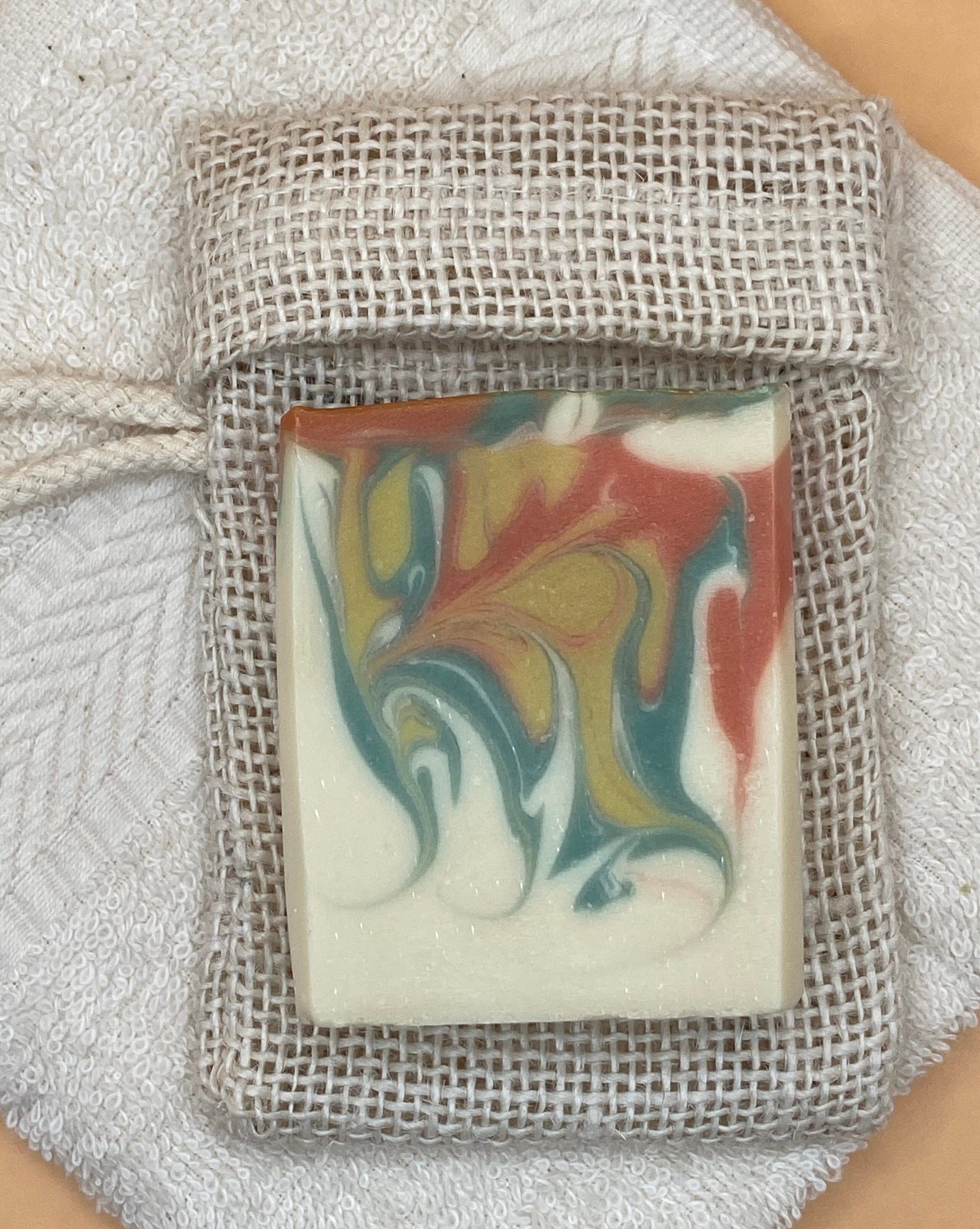 Fig-Vanille Soap laying on top of a soap saver bag.